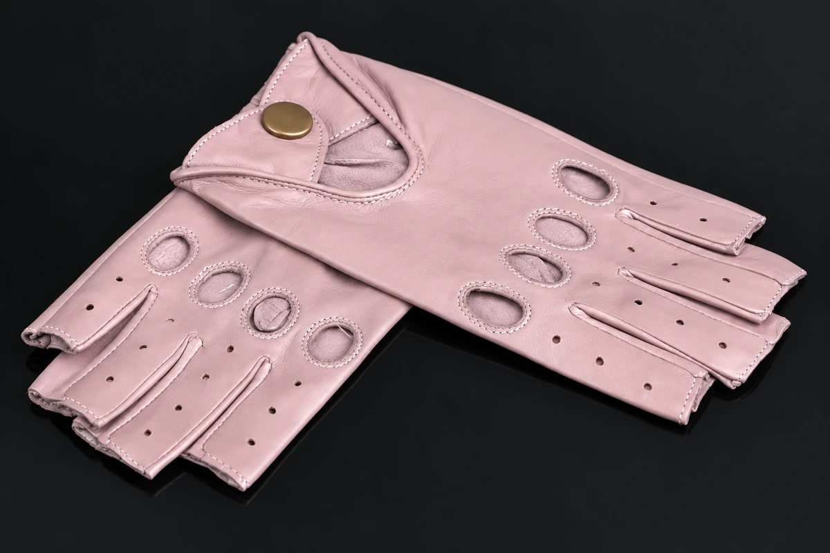 Pink fingerless gloves with stitched knuckle openings and a buttoned wrist strap
