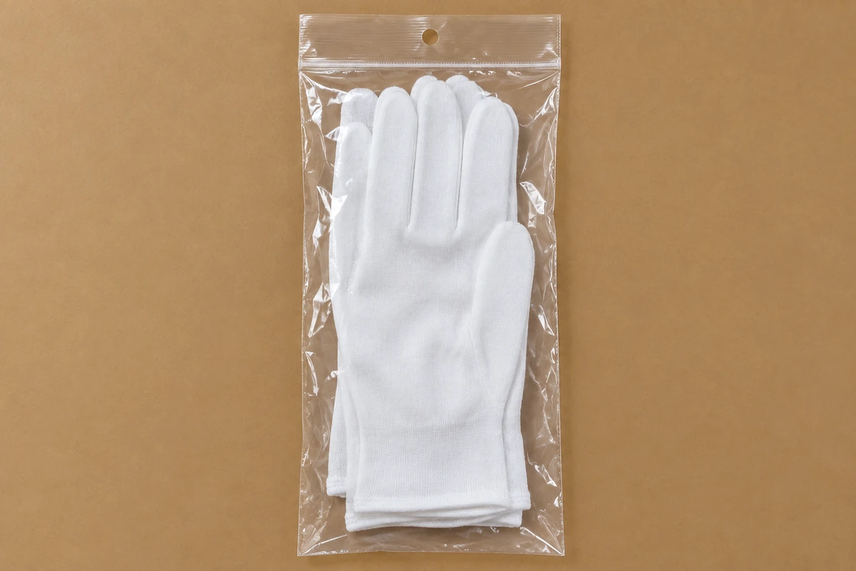 White gloves inside a clear retail pouch