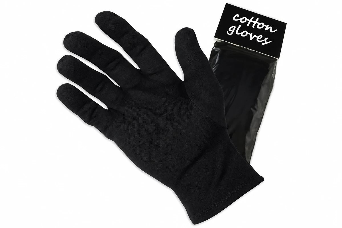 Black fabric gloves attached to a retail card labeled cotton gloves