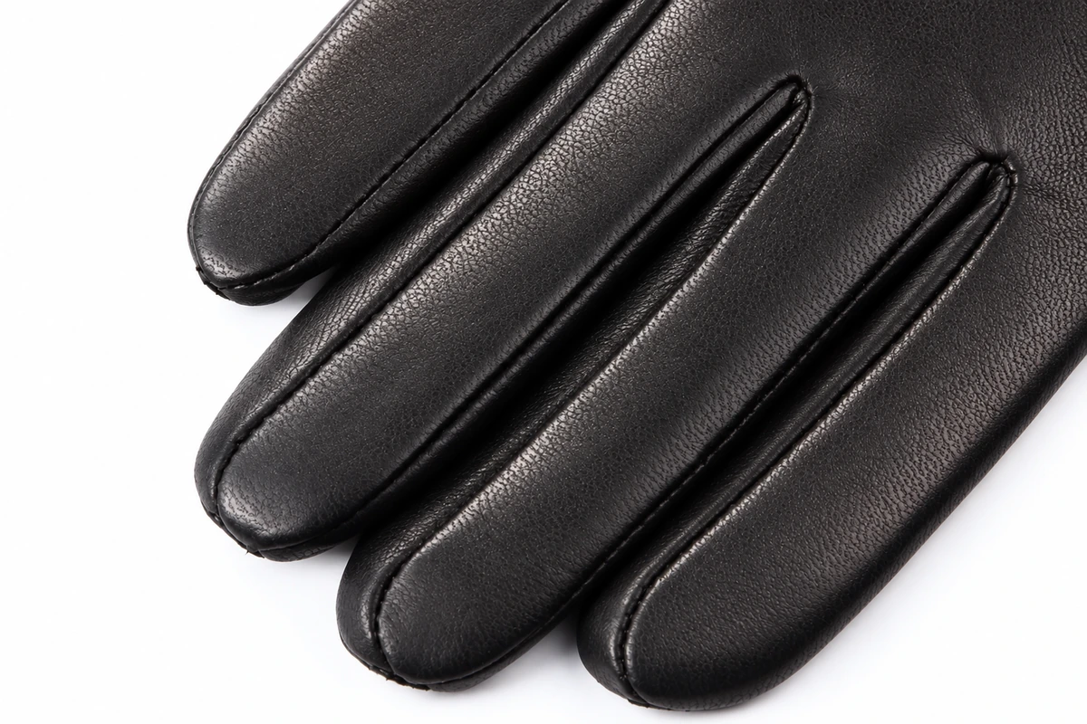 Close view of black leather glove fingers and stitched seams
