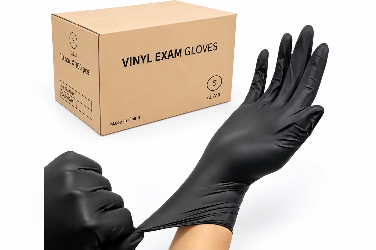 Black disposable gloves beside a carton labeled vinyl exam gloves