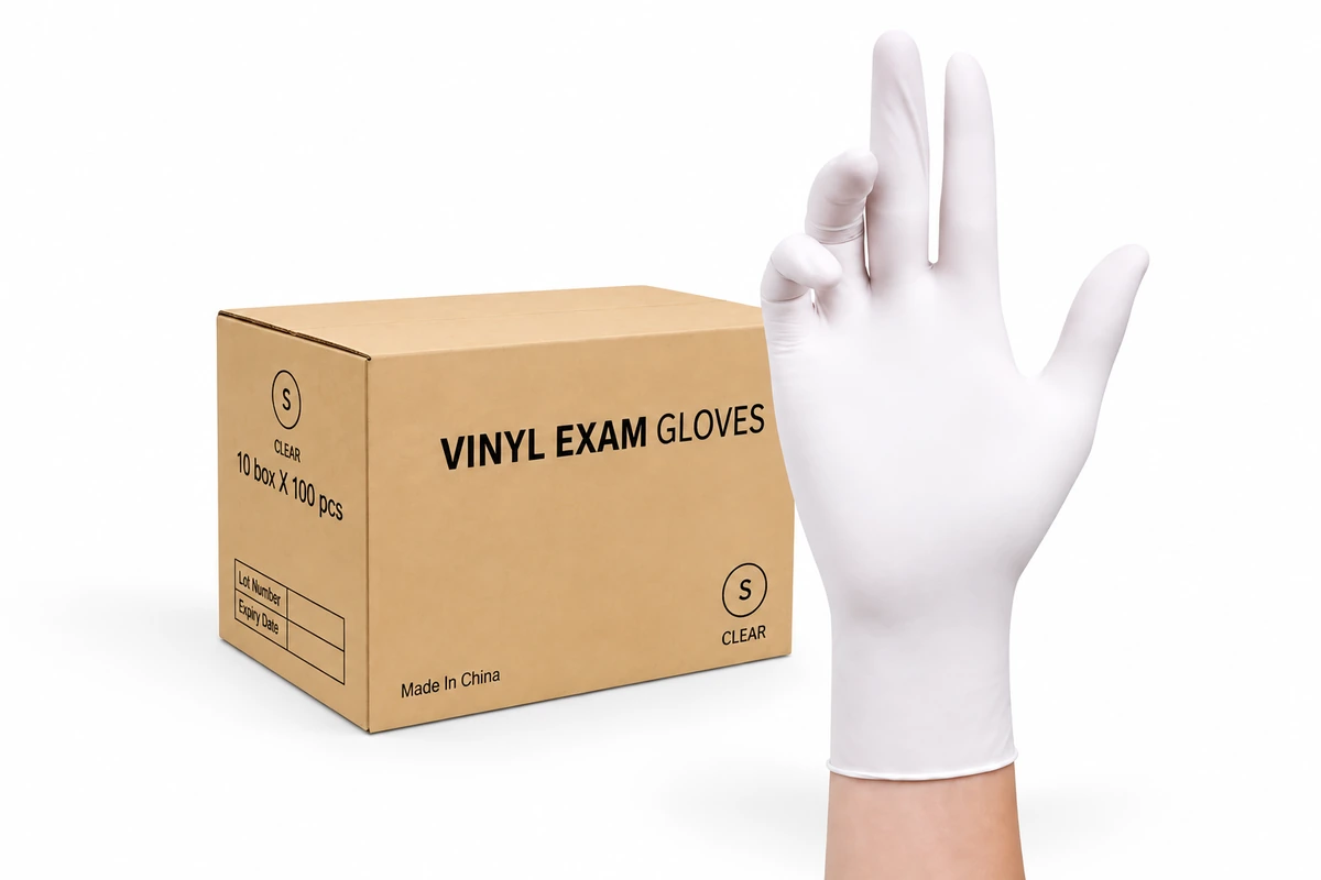 White disposable glove beside a carton labeled vinyl gloves
