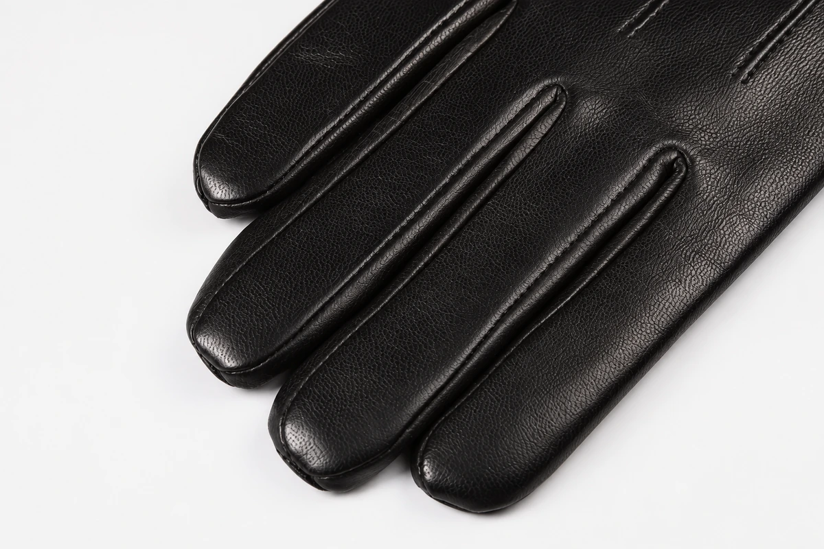 Close view of finger seams on black gloves