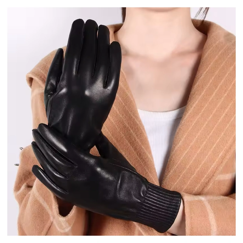 Black leather gloves with ribbed cuffs worn with a camel coat