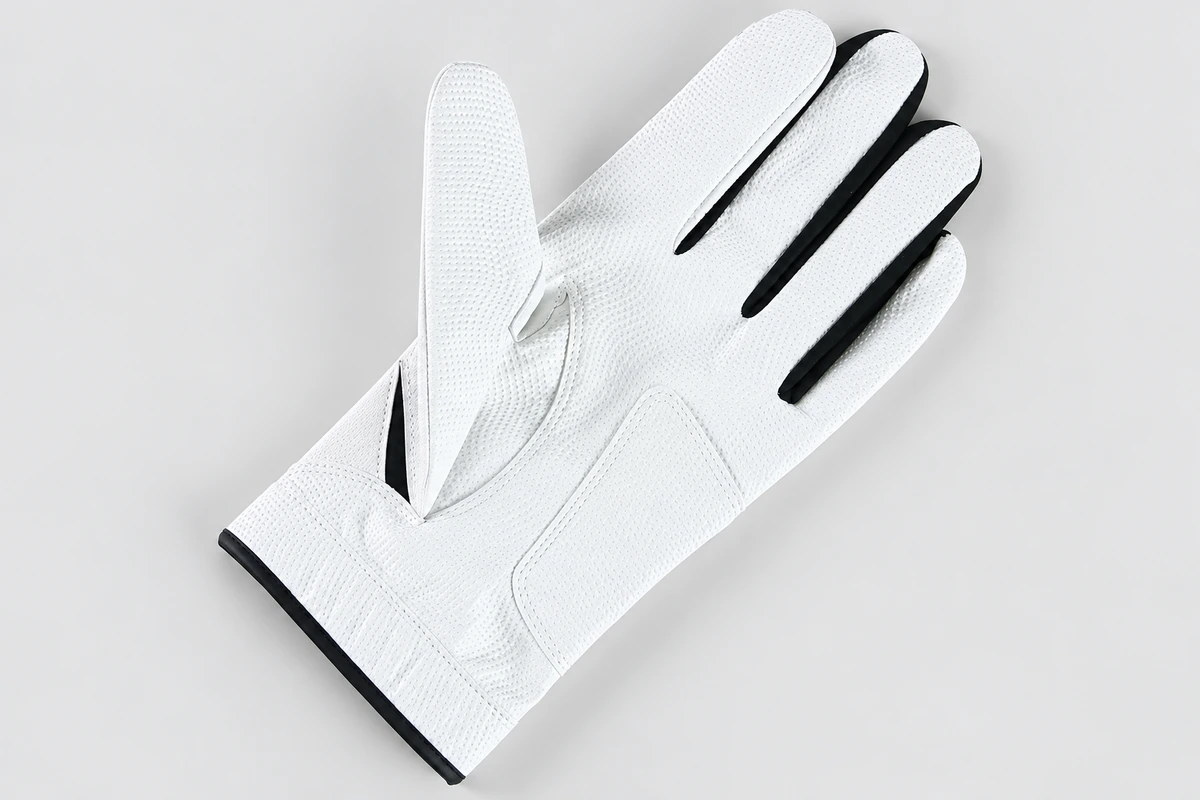 White golf glove showing a smooth palm and dark finger gussets