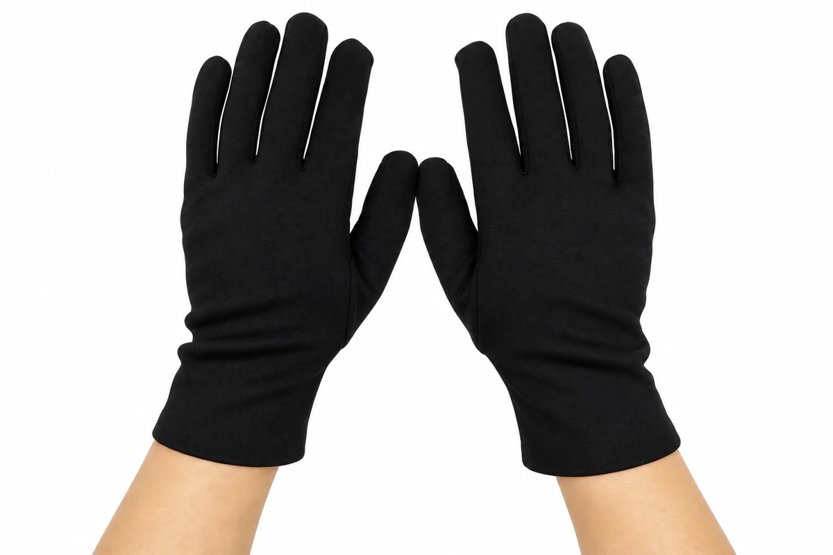 Hands wearing lightweight black fabric gloves with short cuffs