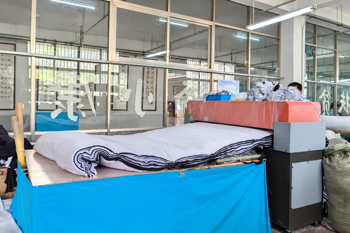 Stacked fabric on the table of a glove-material cutting machine