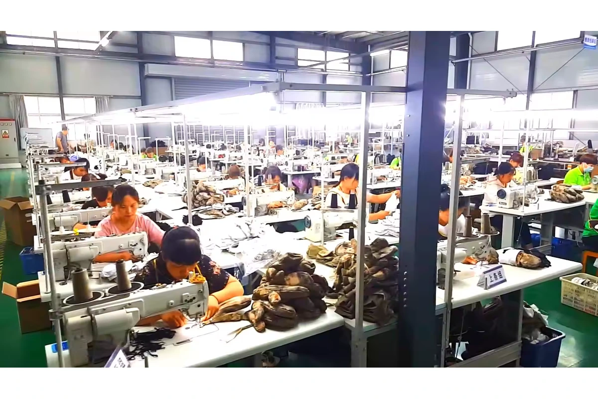 Workers sewing gloves at rows of sewing machines