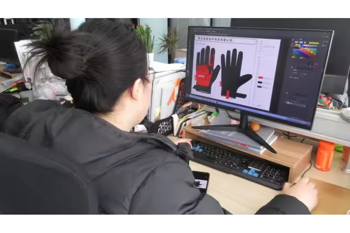 Person viewing red and black glove reference artwork on a desktop monitor