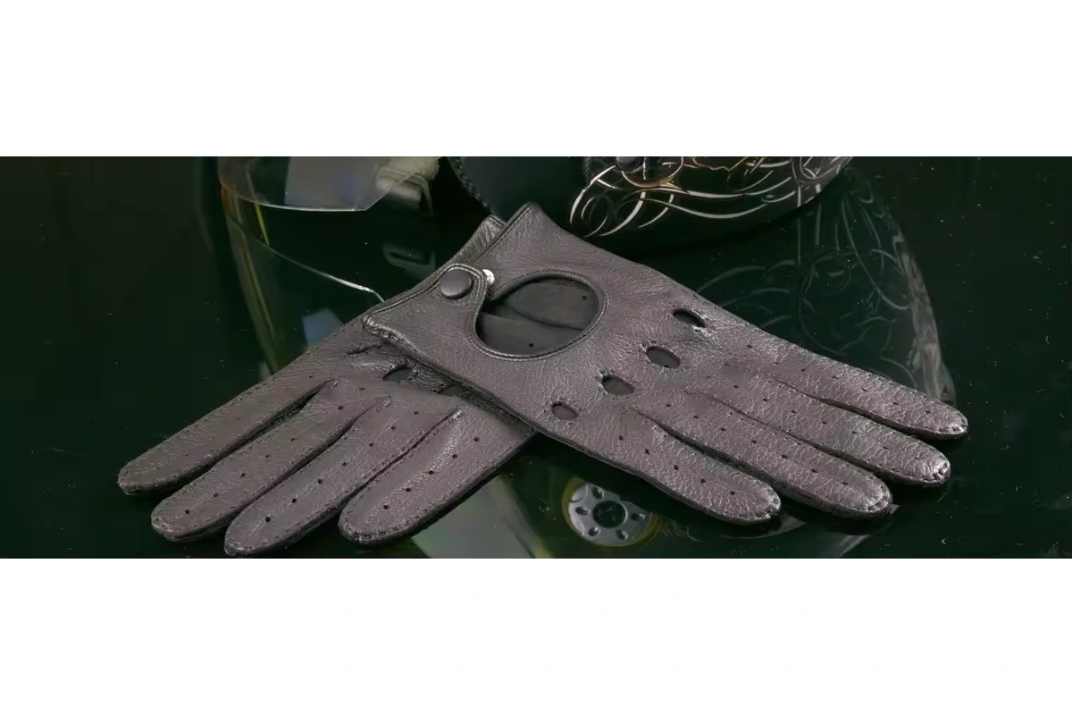 Gray driving gloves with perforated fingers, knuckle holes and wrist buttons