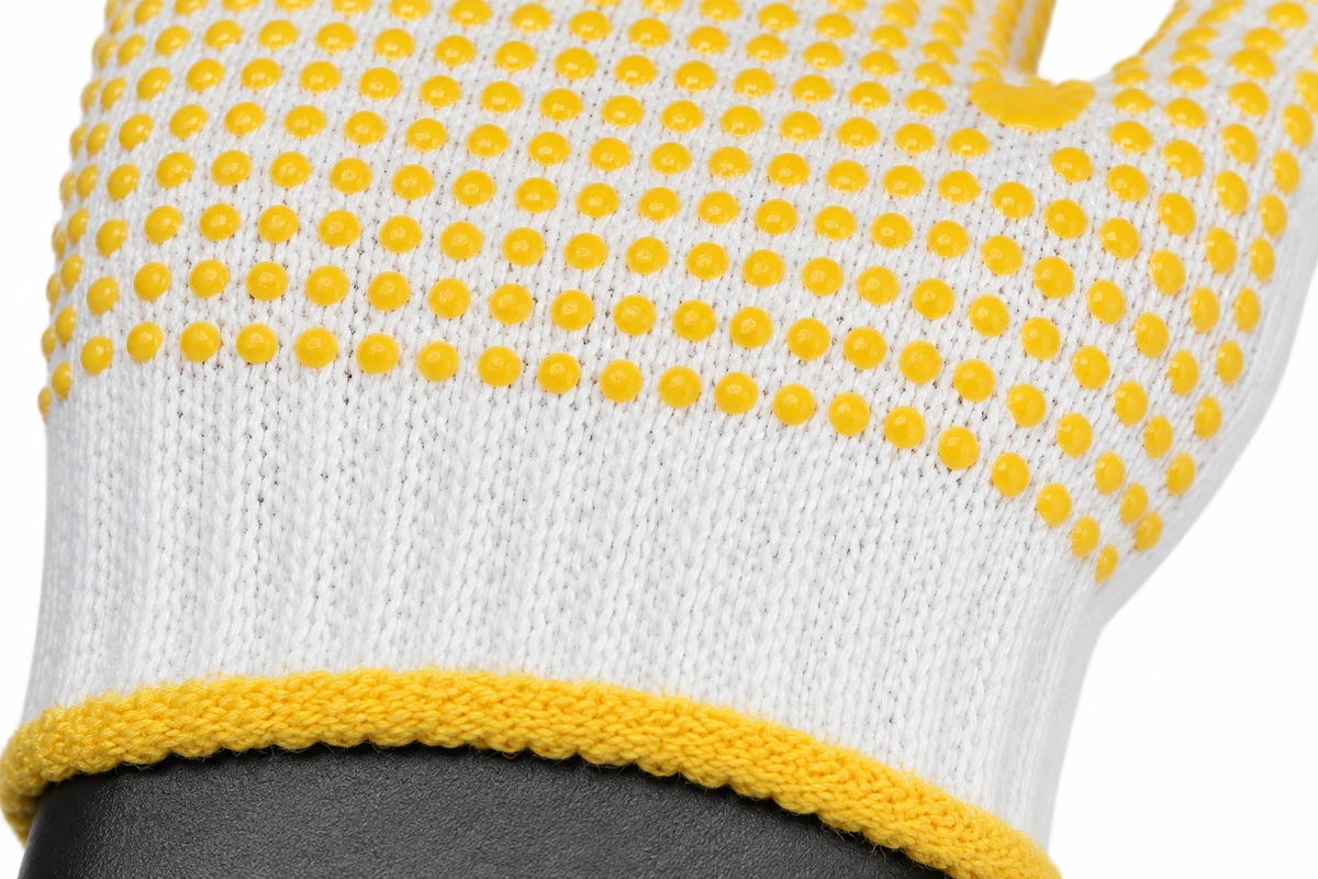 Yellow grip dots on a white knitted glove palm