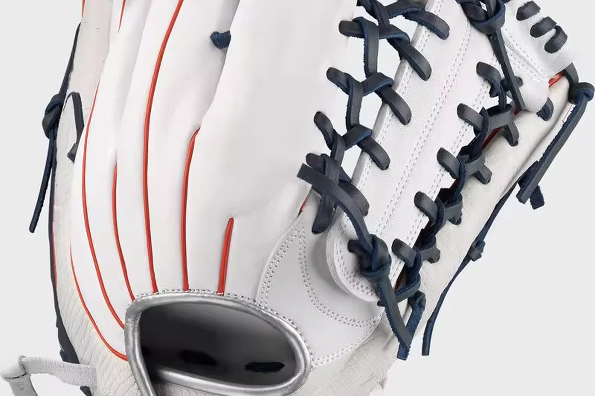 White baseball fielding glove with dark lacing and red stitching