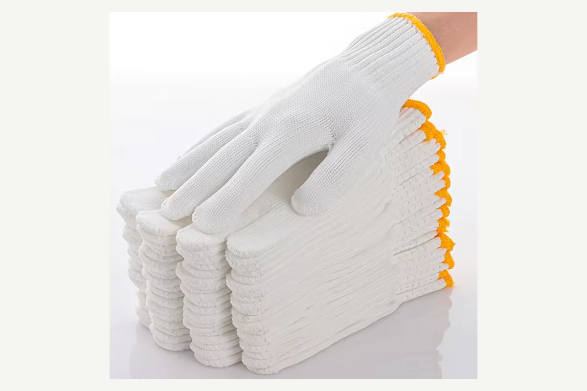 Stacked white knit gloves with yellow-edged cuffs