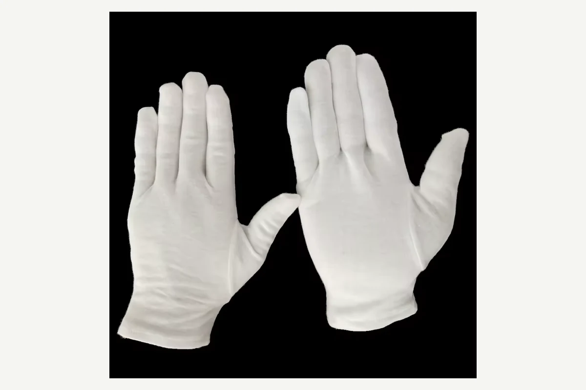 White knitted gloves showing an open palm and the back of a hand