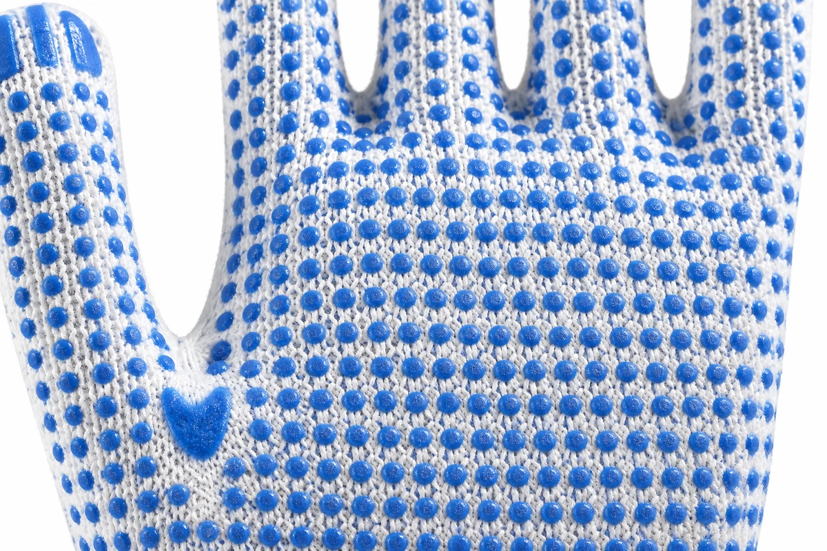 Close view of blue grip dots on a white knit glove palm