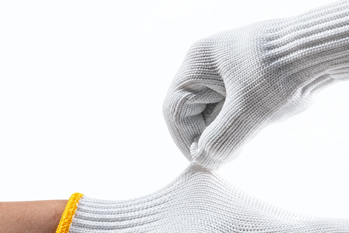 White knit glove cuff pulled to show the wrist opening