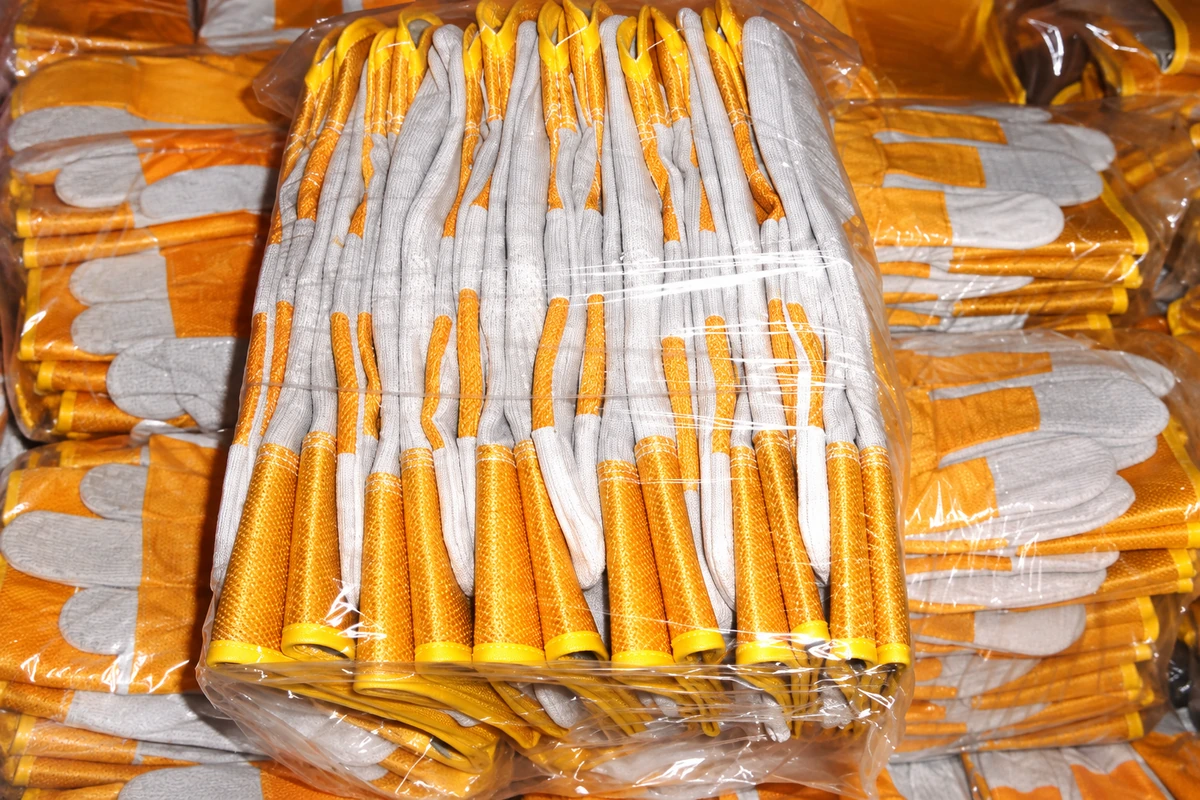 Yellow and gray work gloves bundled in clear plastic wrapping
