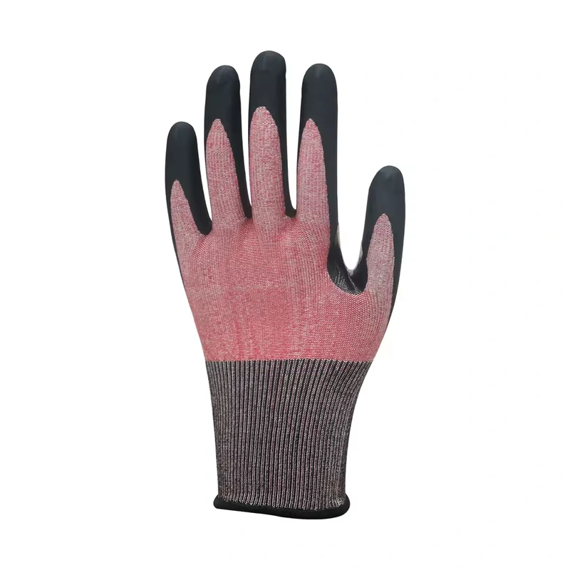 Back of a red-gray knit glove with black coated fingertips