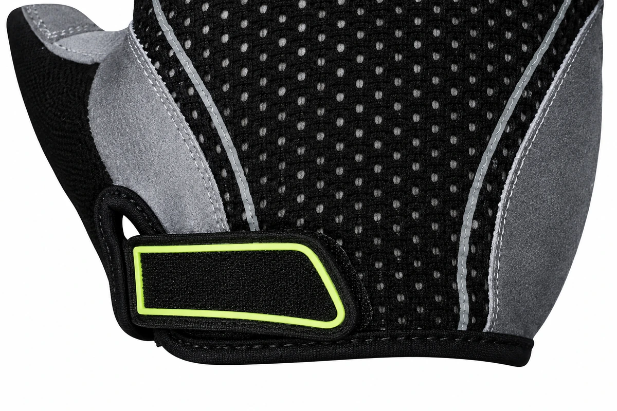 Black glove wrist tab outlined in lime green beneath a dotted mesh panel