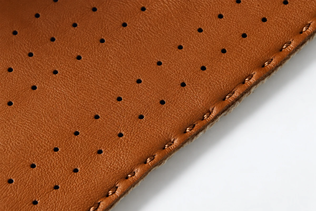 Perforated tan leather with stitched edge