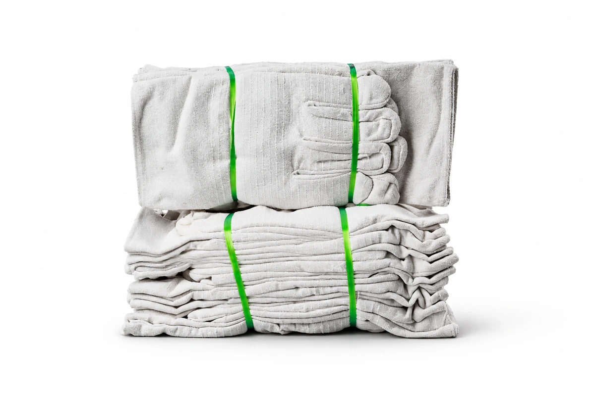 Two bundles of light fabric gloves secured with green bands