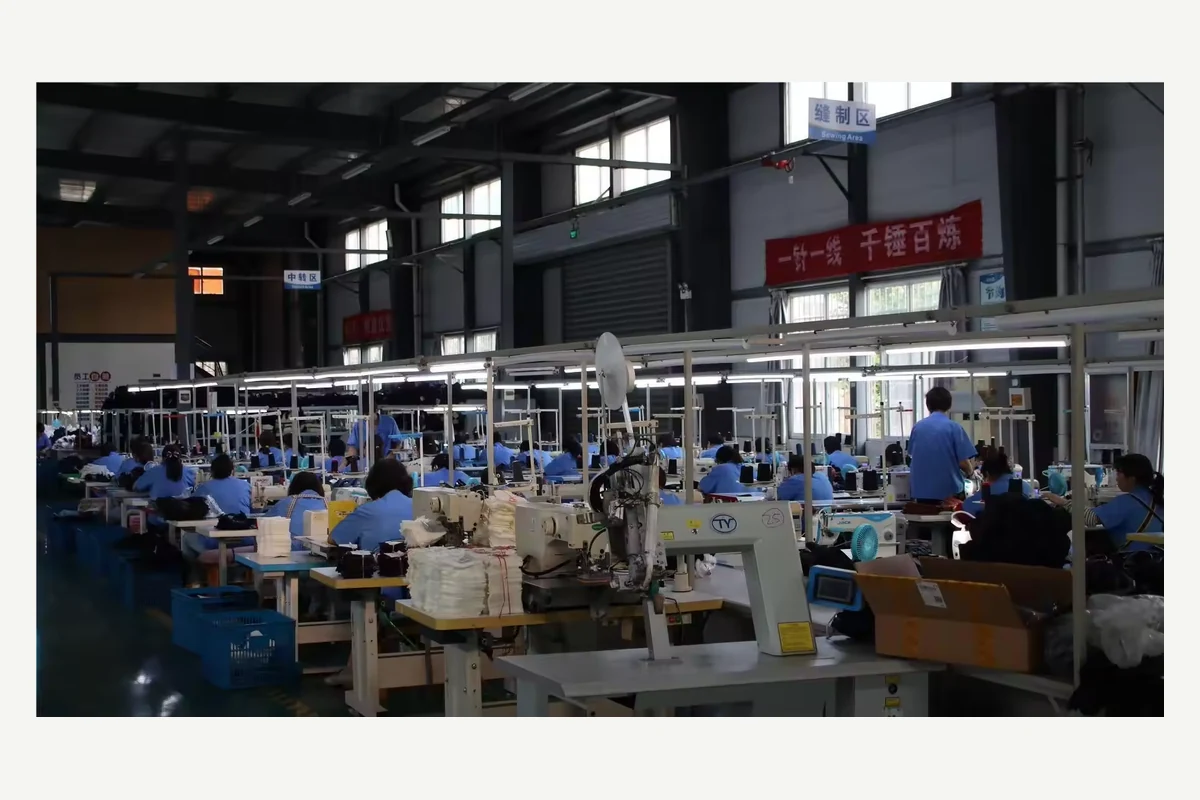 Rows of glove production workstations inside a factory