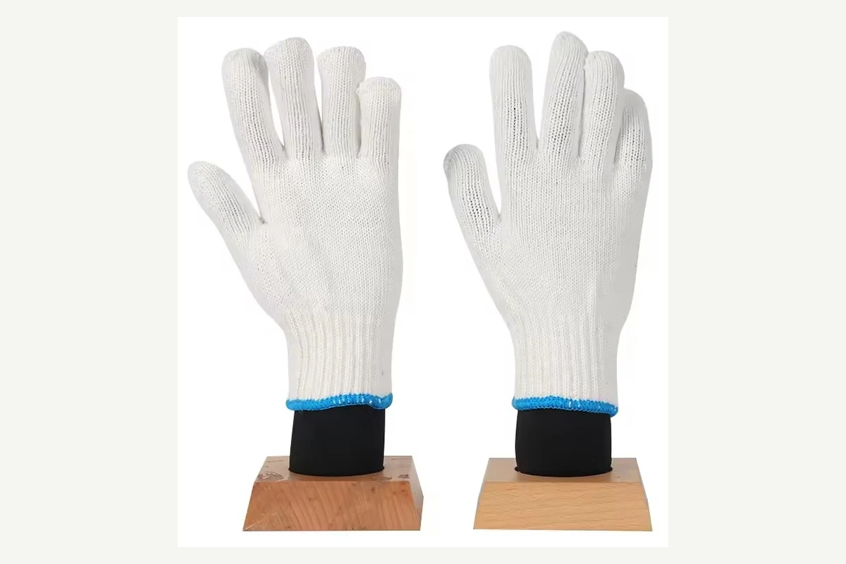 White knit gloves with blue cuff trim worn over black sleeves