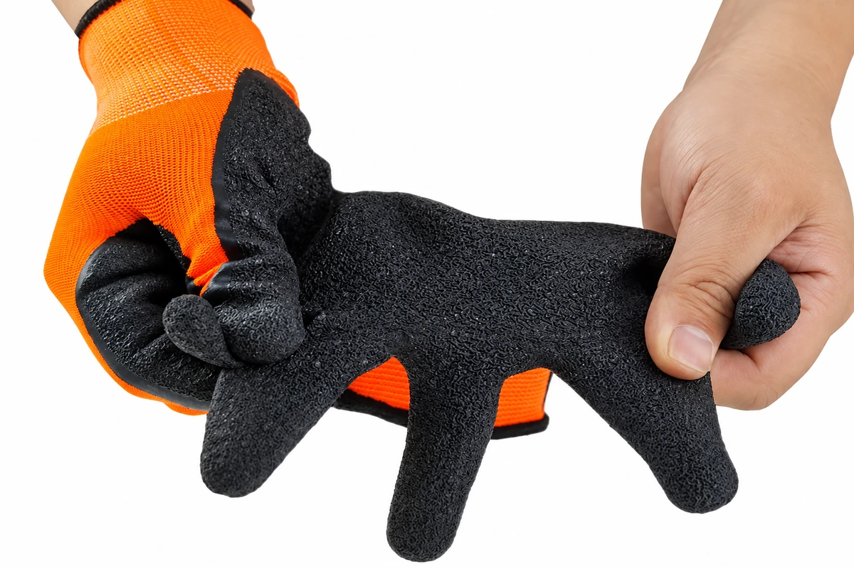 Black textured glove palm flexed between two hands