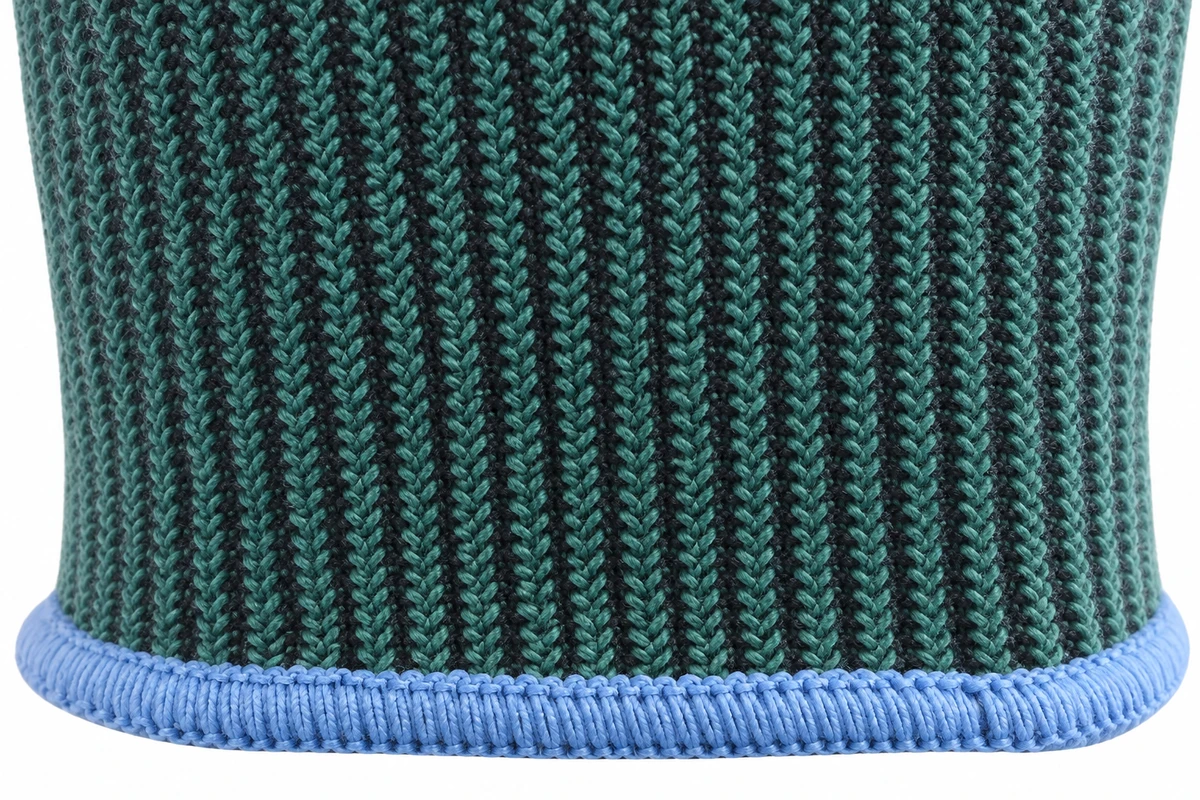 Close-up of a gray and teal knitted glove cuff