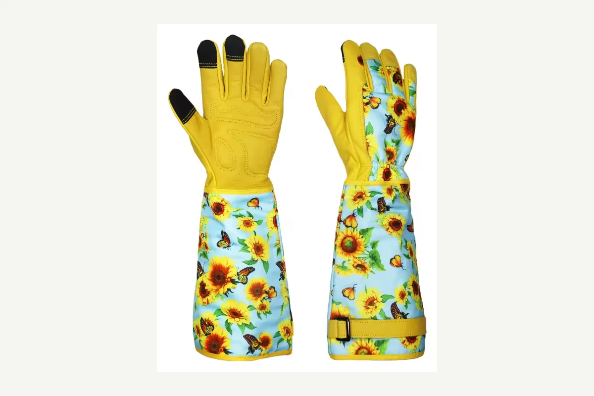 Yellow garden gloves with long floral cuffs and black fingertips