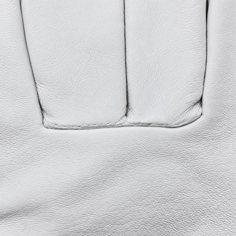 Close view of finger seams and white leather grain