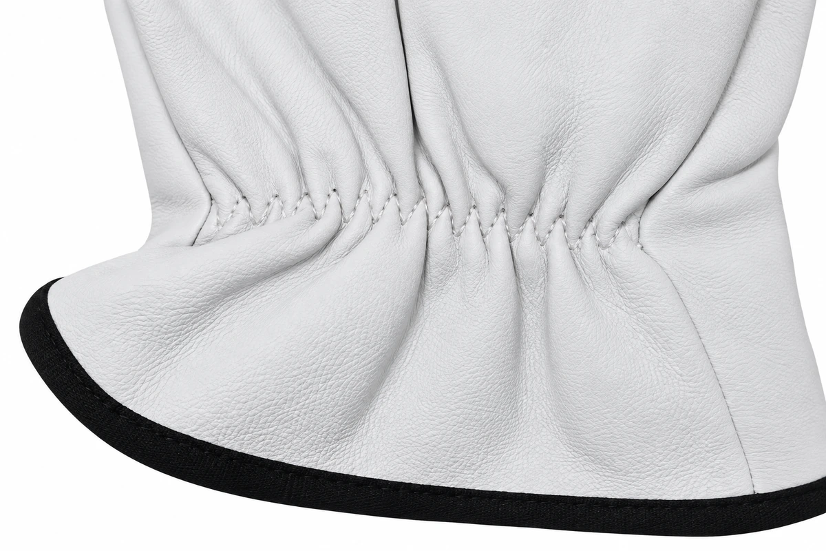 Gathered wrist and black trim on a white leather glove