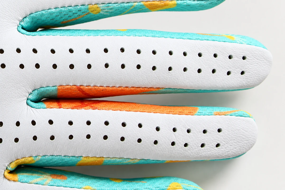 Perforated white glove fingers with multicolor inserts