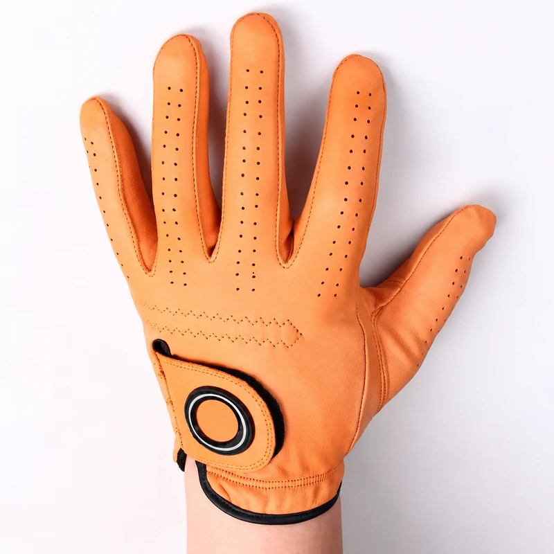 Orange perforated golf glove worn on a hand