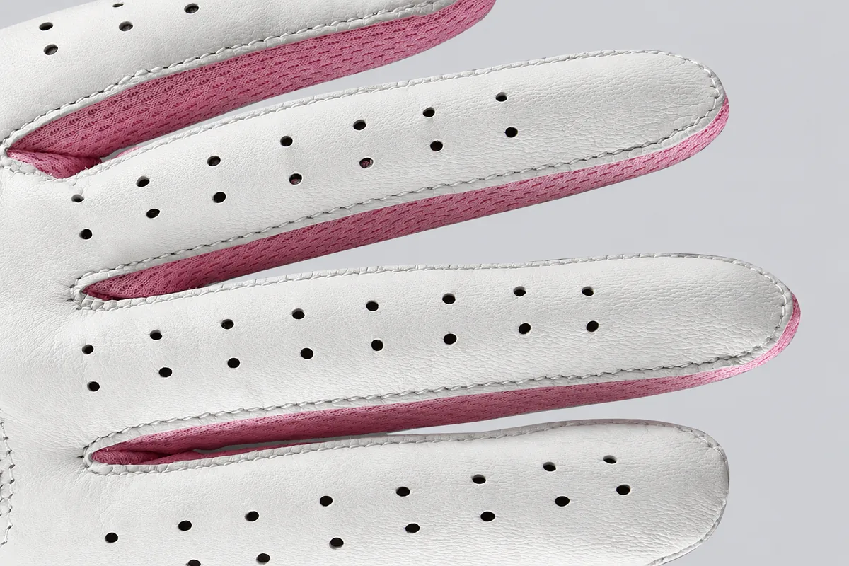 Perforated white golf glove fingers with pink fabric side panels