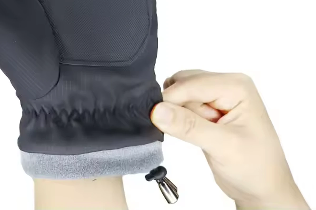 Hand pulling a winter glove cuff with gray lining visible