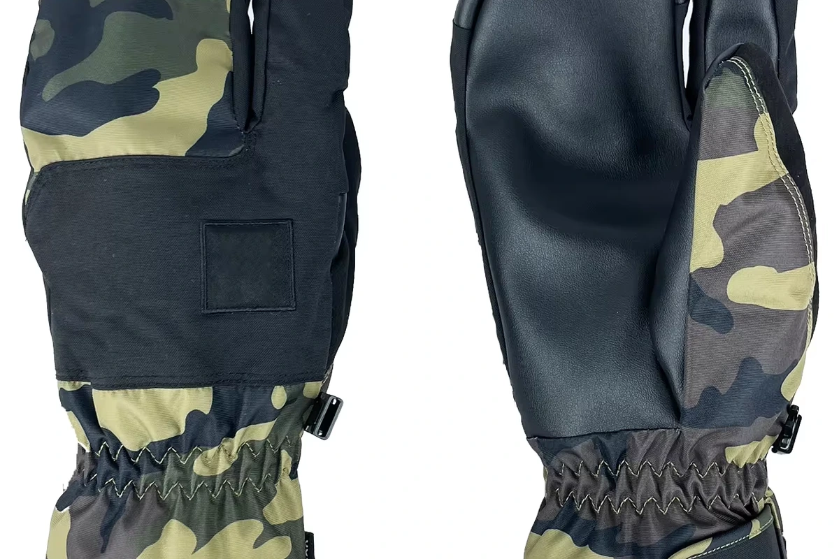 Camouflage mittens showing a black palm and a broad black back panel