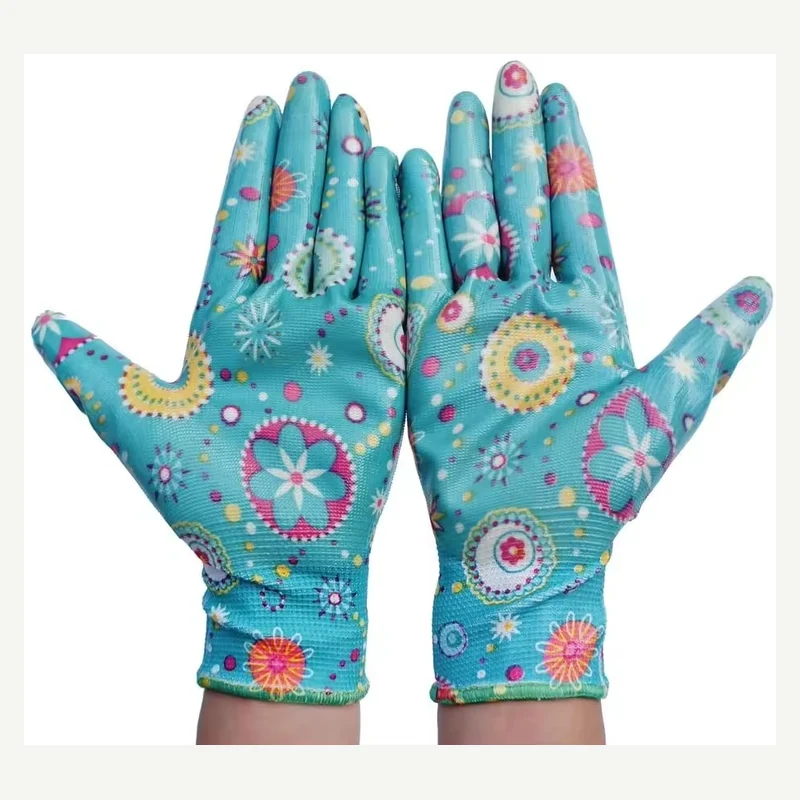 Teal garden gloves with colorful floral patterns worn on both hands