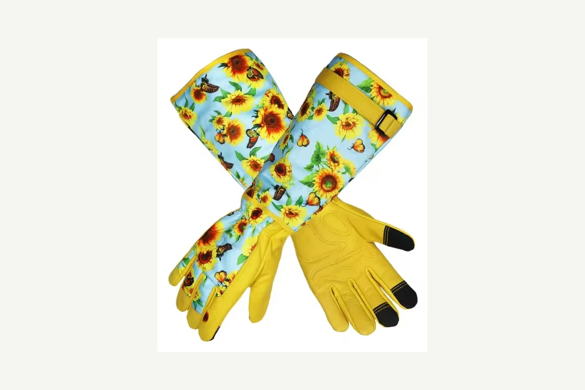 Yellow garden gloves with long floral cuffs and black fingertips