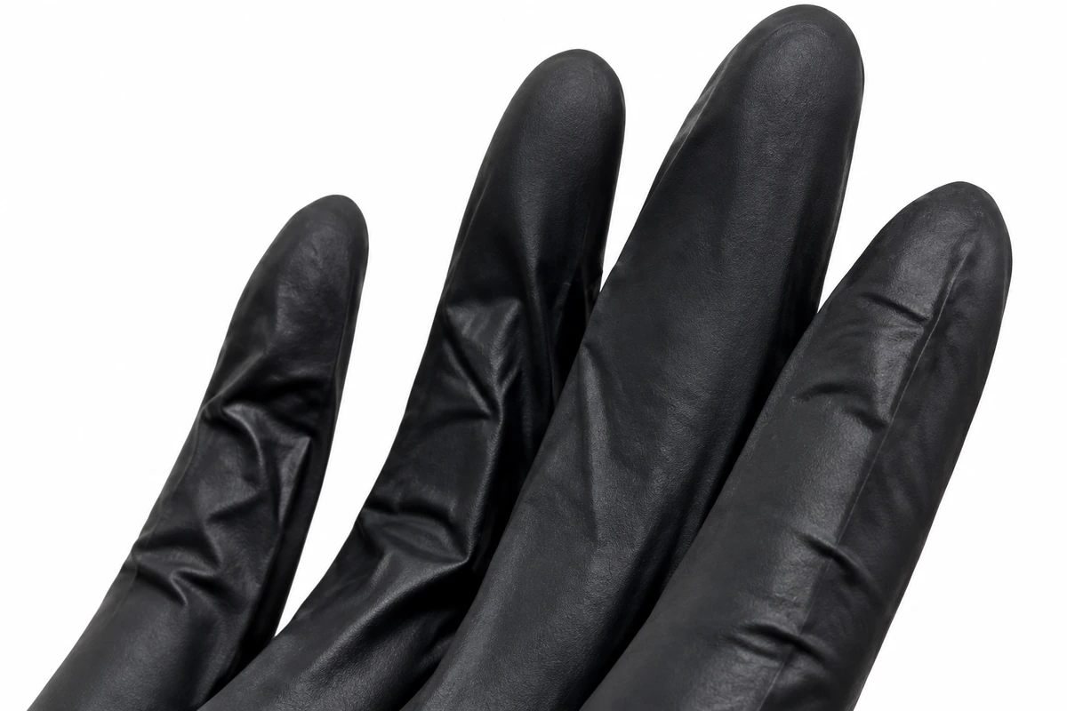 Close view of black latex glove finger folds and surface