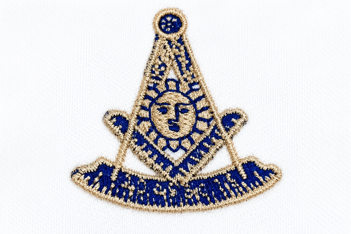 Blue and gold embroidery stitched on white fabric