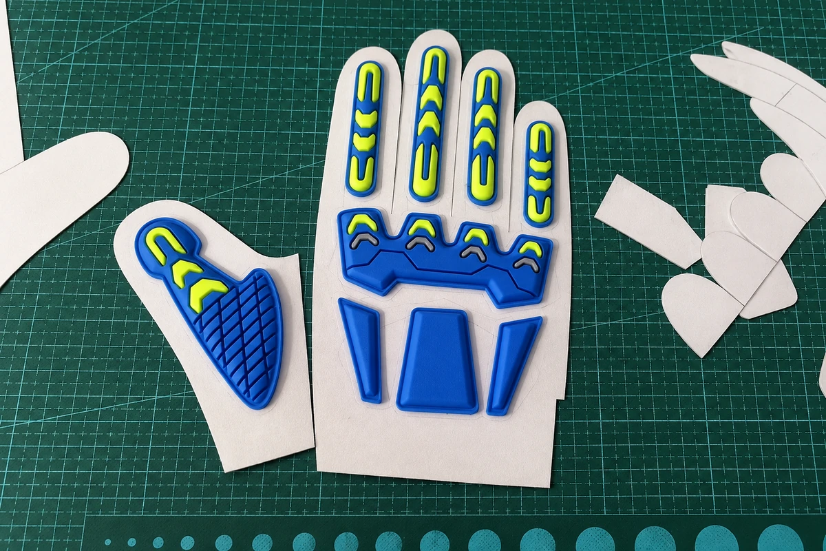 Glove-shaped panels and paper patterns on a cutting mat