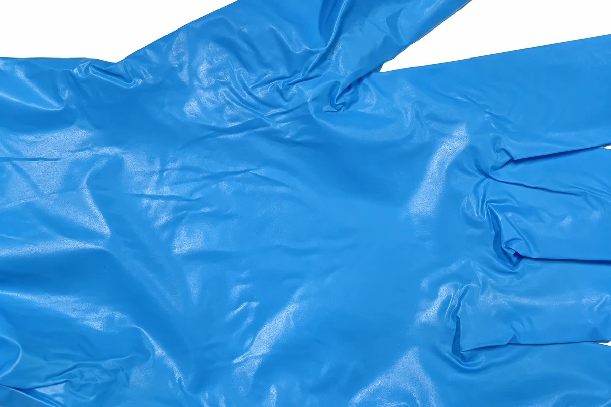 Close view of folds in a blue film glove palm