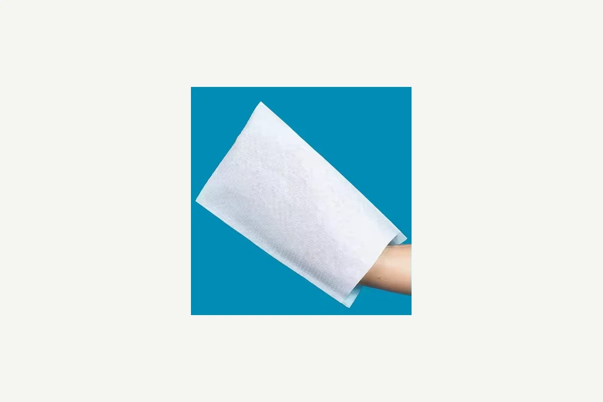 White rectangular cover held over a hand against a blue background