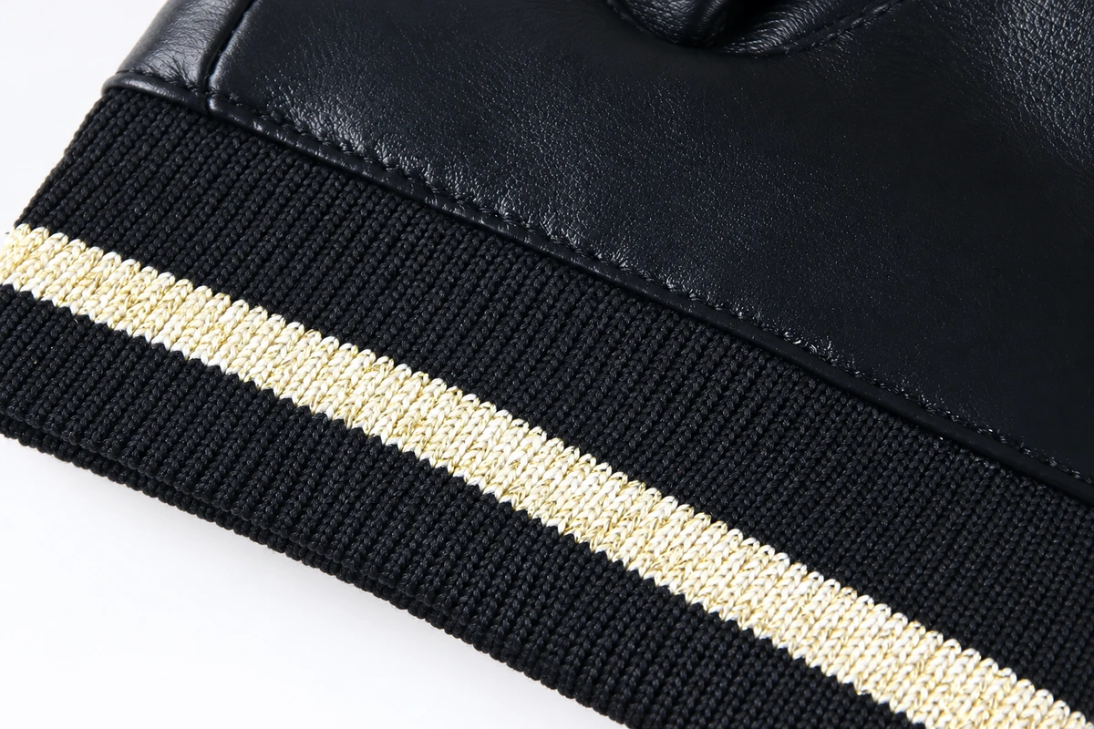 Striped knit wrist joined to a dark leather glove