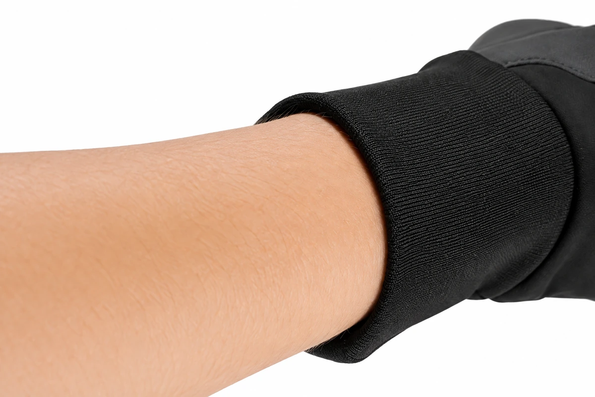 Black knitted glove cuff fitted around a wrist