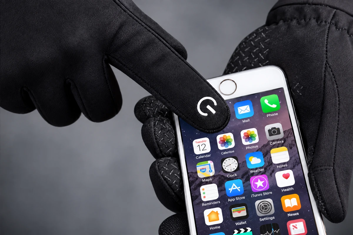 Gloved index fingertip touching a smartphone screen
