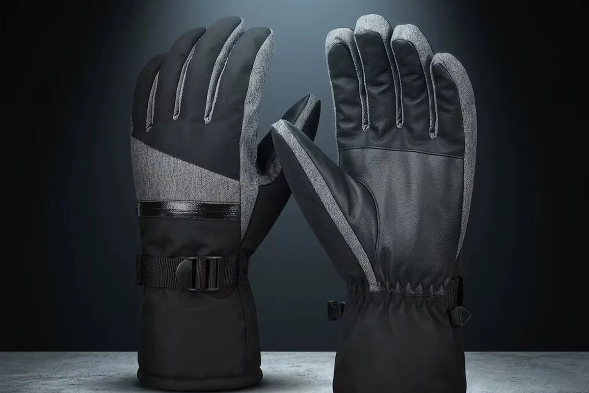 Black and gray outdoor gloves with stitched palm panels and wrist straps