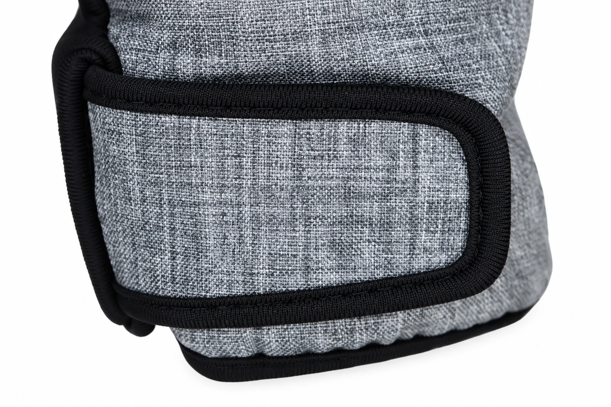 Gray glove cuff tab with black bound edges