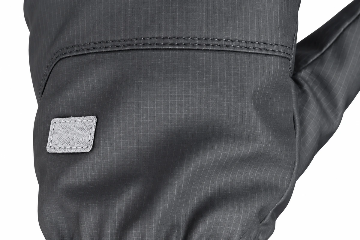 Small fabric label stitched to a gray glove panel